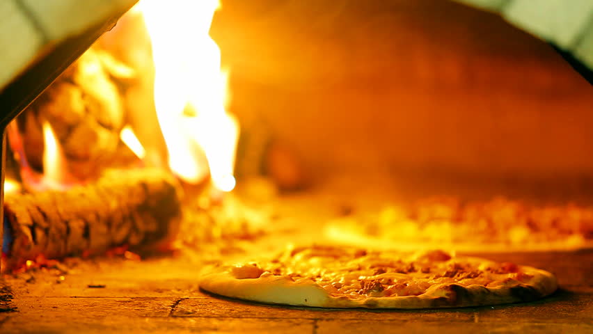 pizza baking in a wood fired oven