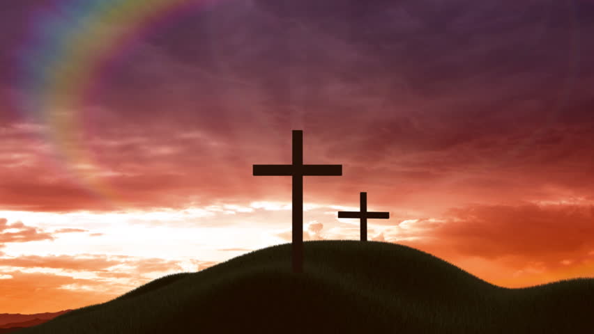 Christian crosses on a hill at sunset