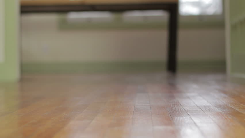 Close up of mother and baby's feet walking across the floor