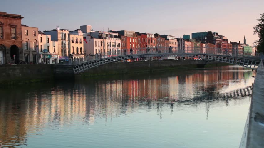 People crossing the Ha'penny Bridge, Dublin, Ireland.