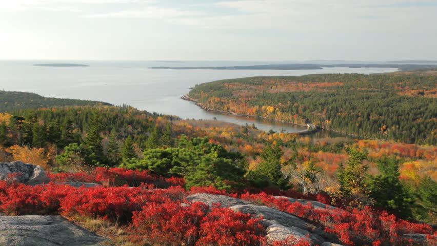 Early morning, aerial zoom in on Otter Cove, in Acadia National Park, Maine in Autumn, with the Cranberry Isles in the background. The bridge is part of the Park Loop Road.