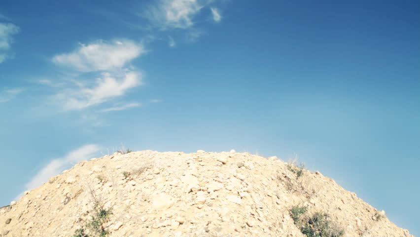 Successful man on the top of the rocky mountain