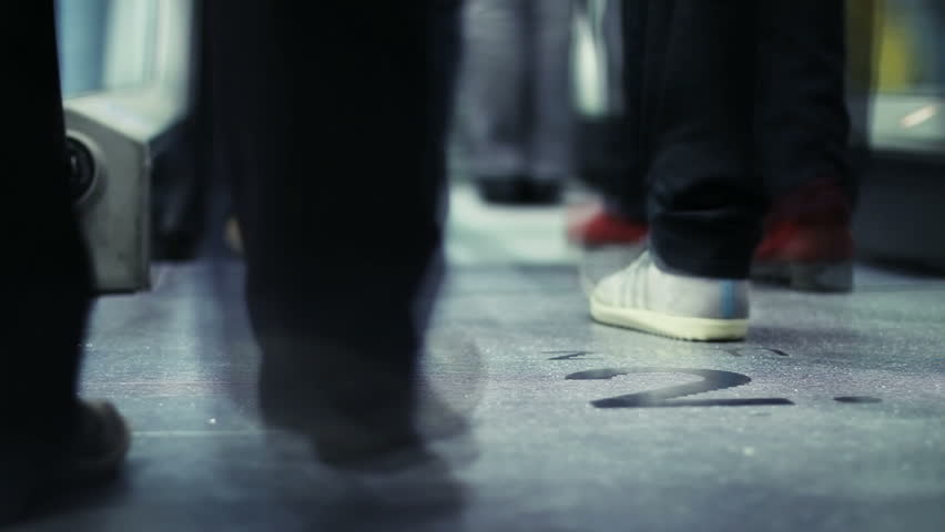 People leg going on fast moving escalator  