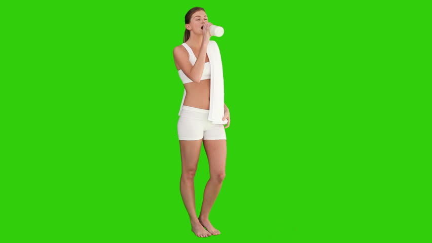 Chromakey footage of a Dark haired female in sportswear drinking water after sport