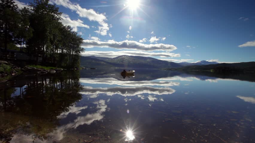 Beautiful blue skies with a boat in Norway - includes non color graded version