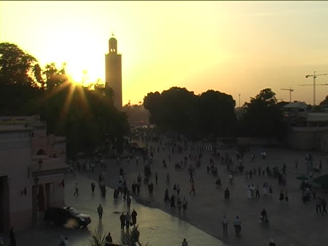 Sunset behind tall minaret in the central medina, Marrakesh, Morocco.