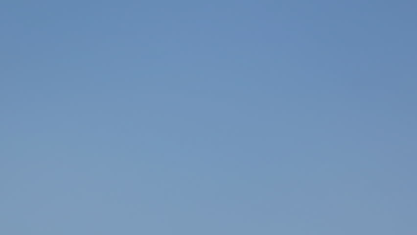 boy clicks clapperboard and walks away against blue sky