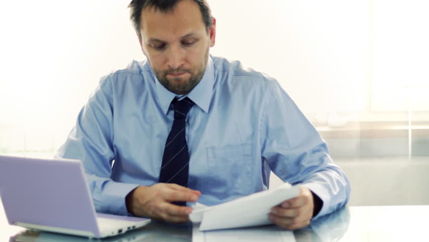 Businessman overwhelmed by paperwork