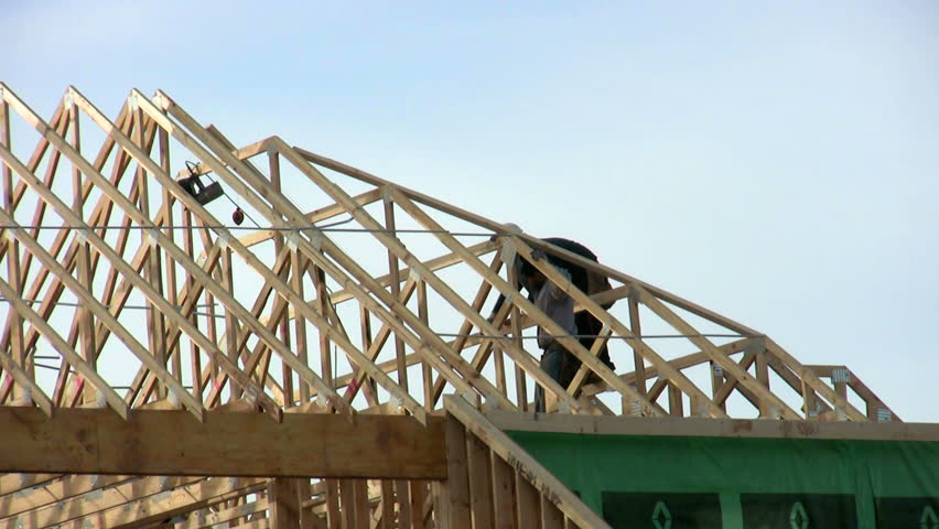 Roofers working on building a roof