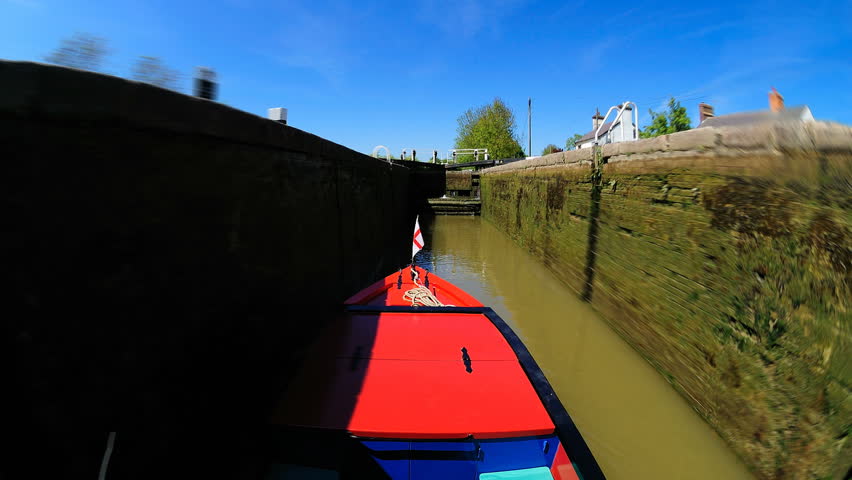narrow boat moving through locks along the Grand Union Canal, UK. Camera is fixed to roof of boat