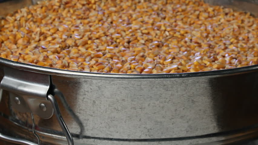 Flyover of corn to reveal flasks and beakers of experimental biofuel products, such as biodiesel and ethanol.