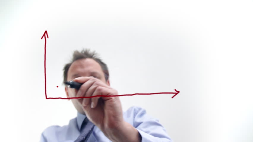 Businessman drawing growth graph on the glass