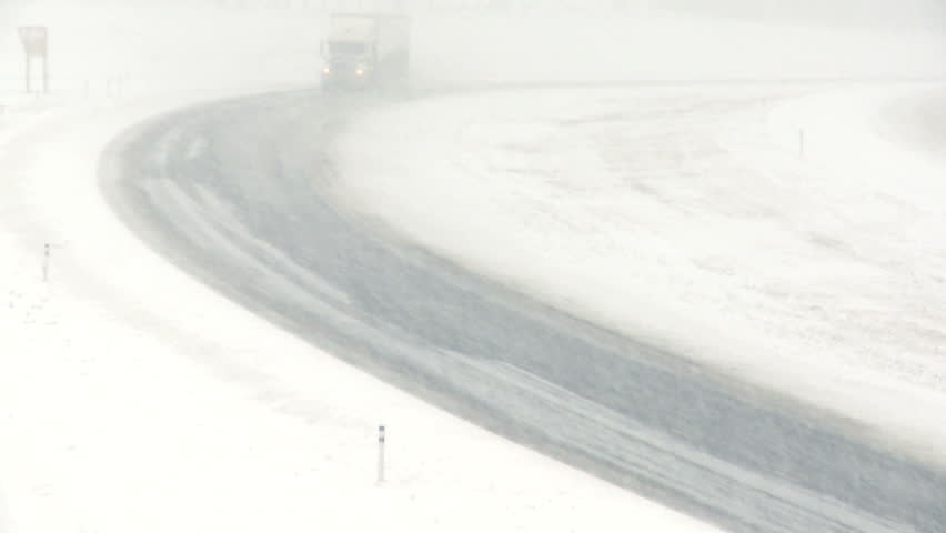 Highway truck traffic during blizzard