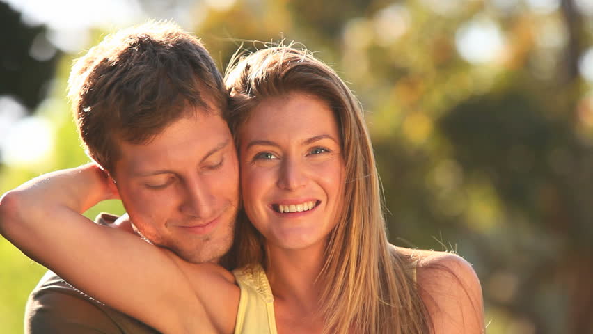 Attractive couple cuddling in a park