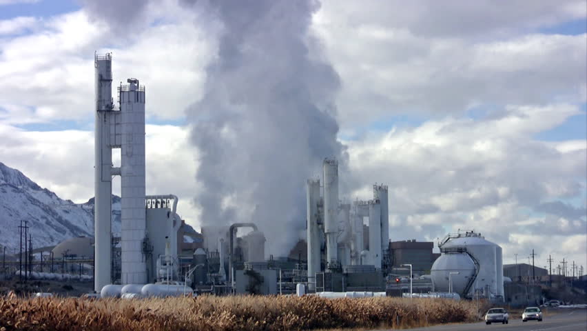 Video of the refinery smelter at Kennecott Copper Mine in Utah. Main highway with traffic. Pollution, steam and smoke from smelter. 