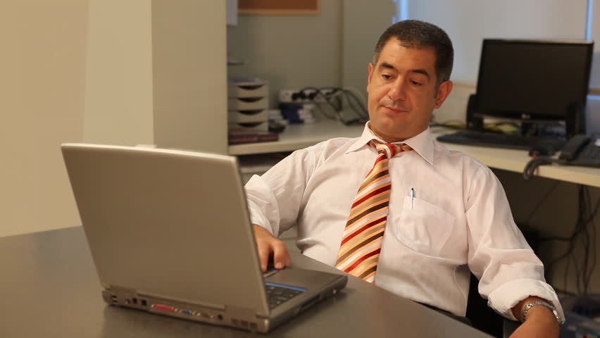 Tired businessman using laptop in office - Work - Waiting - Overworked - Technology - Business  