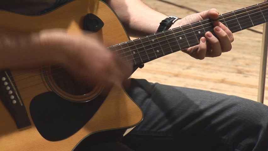 playing acoustic guitar