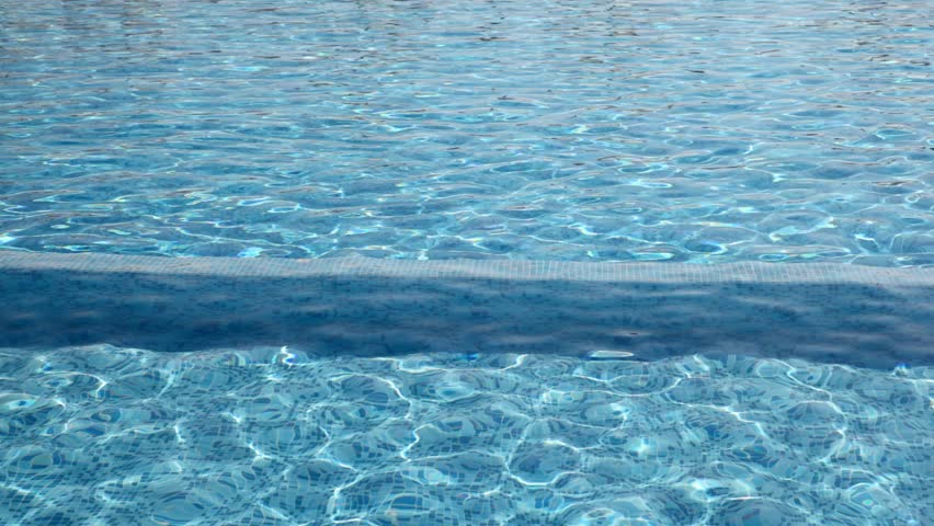 Boy ran along the border in pool from right to left