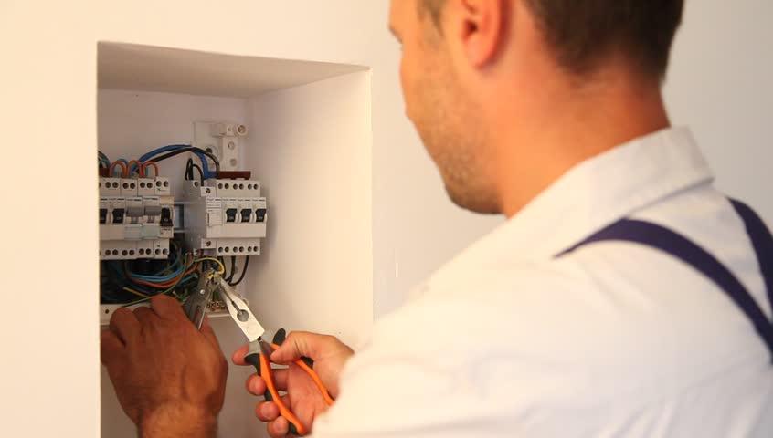 Electrician installing electric meter