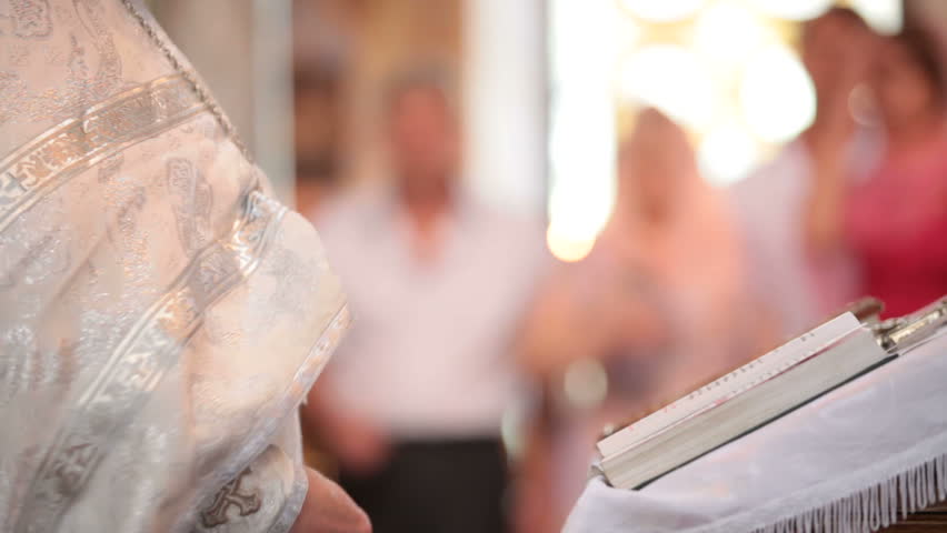 Priest reading the Bible in church