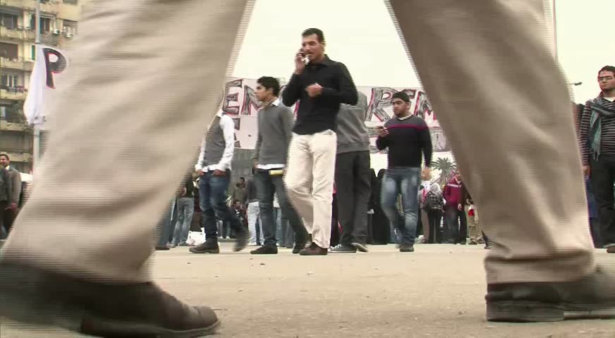 CAIRO - CIRCA JAN 2011: Pedestrians in Tahrir Square, circa January 2011, Cairo, Egypt. Tahrir Square was the focal point of the 2011 Egyptian Revolution where demonstrations grew to 250,000 plus people by day 6, January 31, 2011.