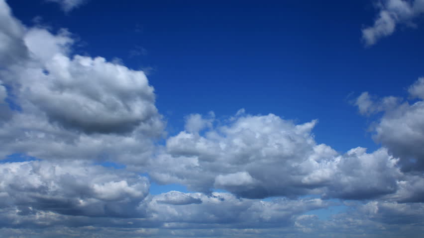 Fast running clouds in the blue sky.