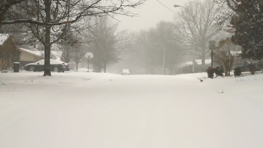 Snow falling on a suburban neighborhood street