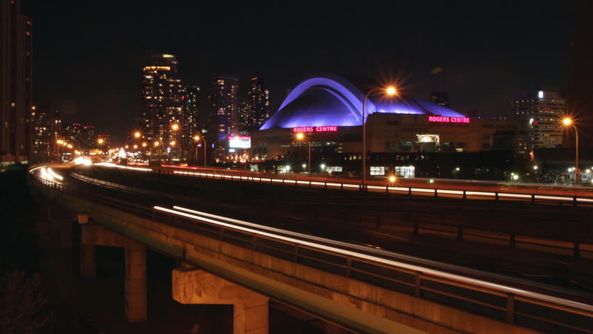 TORONTO - JUNE 4: Traffic with Rogers Centre (formerly Skydome) in Toronto, Ontario, Canada on June 4, 2010. Opened in 1989, it was the first stadium to have a fully retractable motorized roof