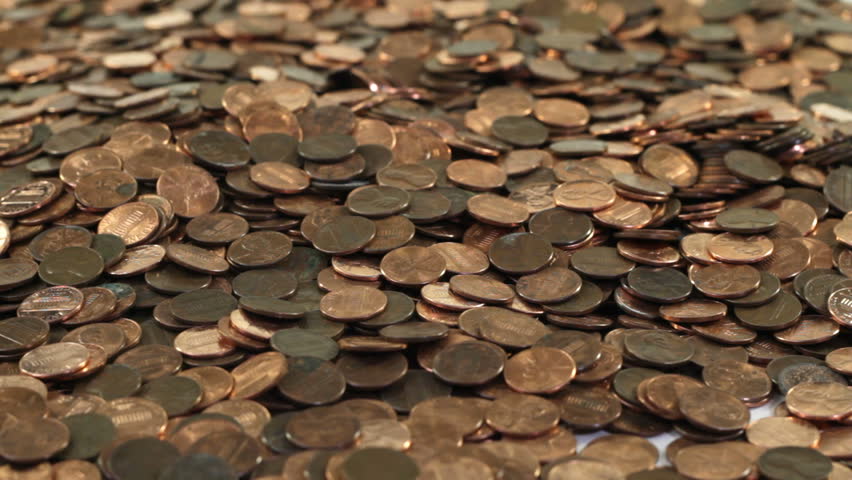 Slow trickle of pennies falling on a pile of pennies.
