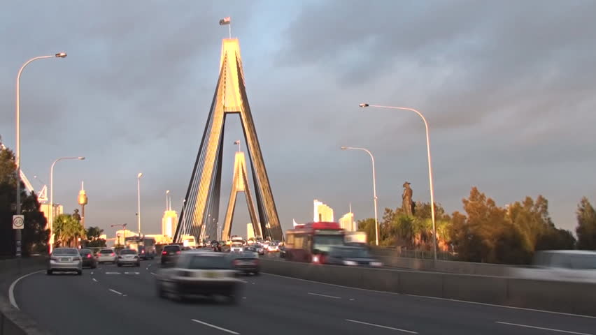 Late afternoon traffic rushes through the ANZAC Bridge in Sydney, Australia. Time-lapsed video.