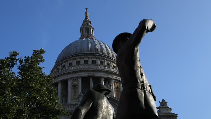 Smooth tracking time lapse of the dome of St Paul's Cathedral in London. In the foreground is the statue remembering the firemen who lost their lives during the Blitz in the Second World War.