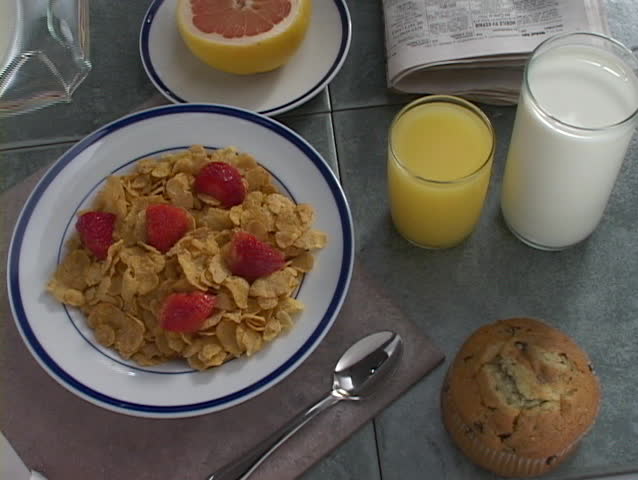  A pitcher of milk poured on cereal