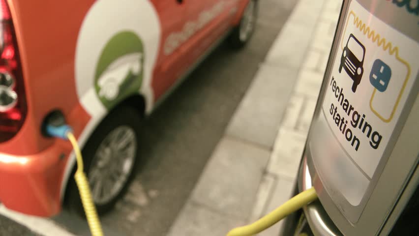 Electric car wired to charging station 