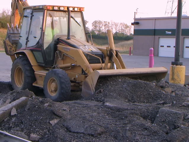 Backhoe Loader Pushing Pavement - audio from external microphone.
