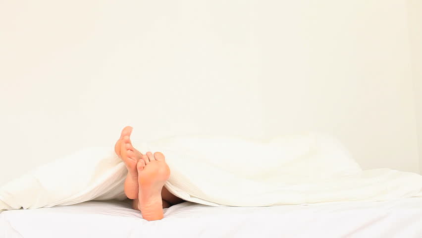 Wobbling toes in a bed in the bedroom