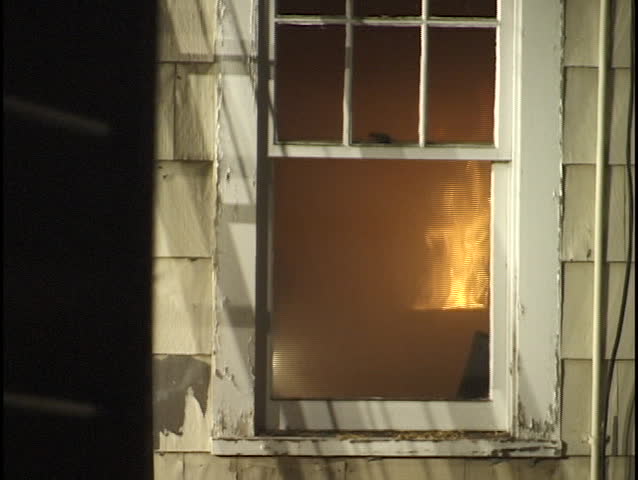 house on fire with fireman inside