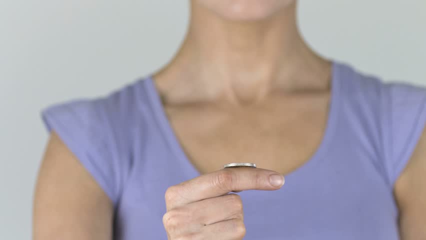 Woman flipping a coin filmed at 1,000 frames per second