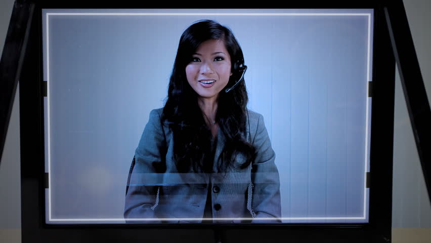 Futuristic touchscreen graphic technology being accessed by Asian sales woman in a modern call centre office