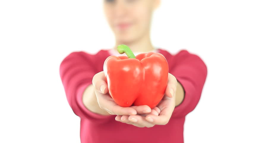 Female hand offering red pepper, isolated on white 