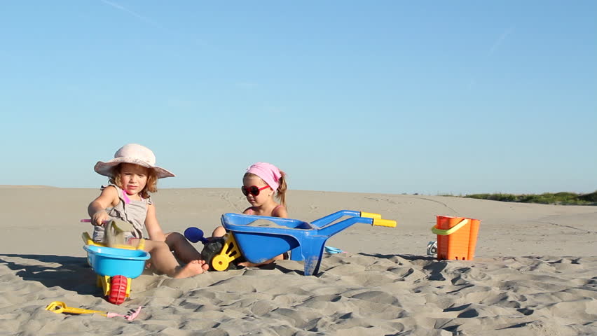 two little girls playing in sand