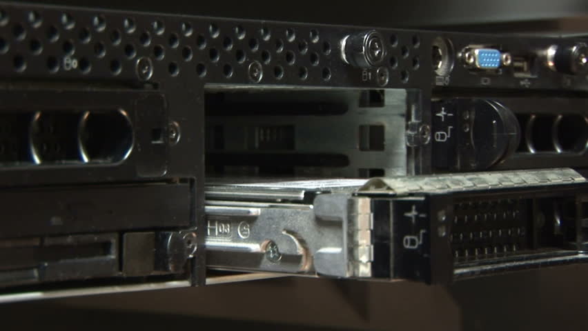 technician replacing hard drives in a network server