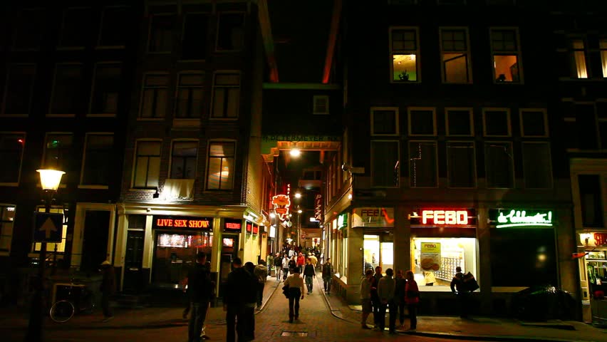 AMSTERDAM, NETHERLANDS - APRIL 16: Tourists visit the red-light district of Amsterdam, April 16, 2011, Amsterdam, Netherlands.