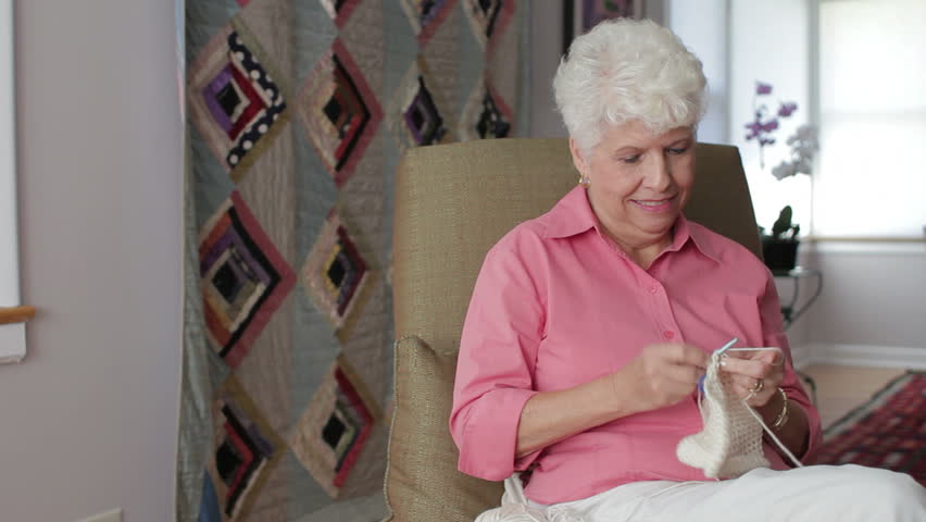 Senior woman crocheting at home