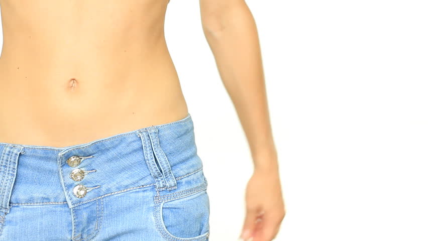 Woman in jeans measuring her belly and showing ok sign, isolated on white