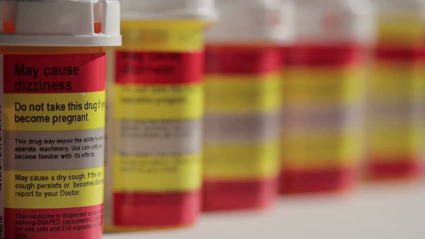 Dolly shot of prescription pill bottles