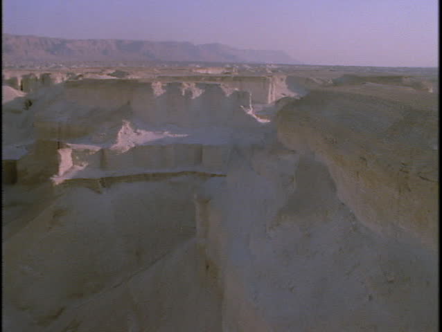 Mountains rise out of a barren desert in this spectacular aerial shot.