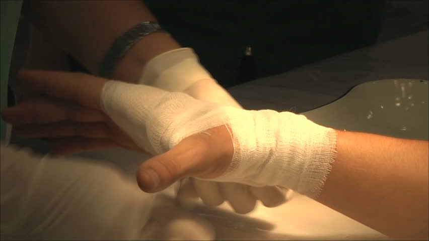 doctors impose a bandage on the patient's arm
