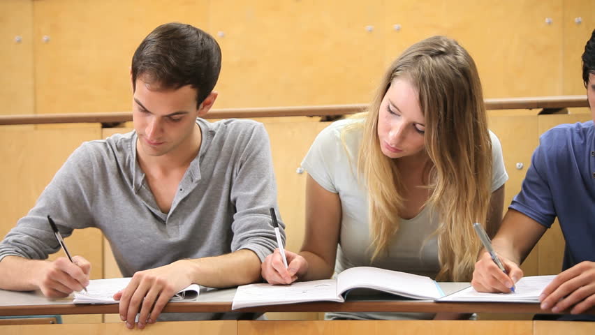 Fellow students taking notes during a lecture