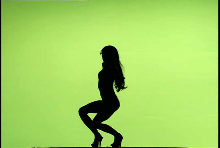 A silhouetted woman dancing against green background