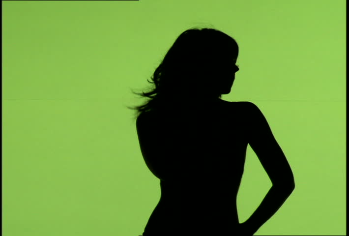 A woman's silhouette dancing against green background